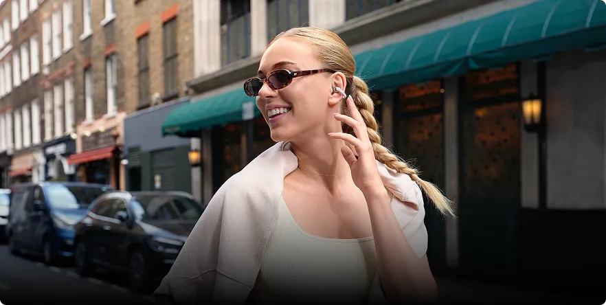 Shokz OpenDots ONE open earbuds with no parts inside ears for hygiene.